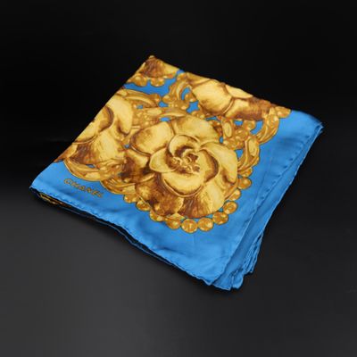 a close up of a blue and yellow handkerchief on a black surface