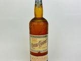 an image of a bottle of liquor sitting on a white surface