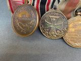 three medals are sitting on a table next to a ribbon