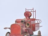 a red toy fire truck with a fire hydrant on the back of it