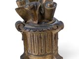 an image of a bronze vase filled with vases on top of a white surface