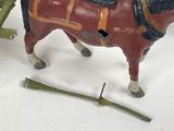 a toy horse pulling a cart with a man on it