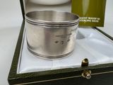 a silver cup that is in a box on a table