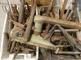 a pile of old tools in a bin on the floor