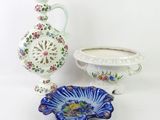 two vases and a bowl on a white table