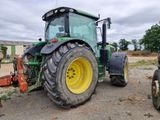 a tractor that is parked on the side of the road