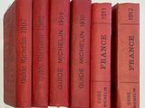 five red books stacked on top of each other on a table