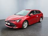 a red toyota coroll is parked in a room