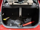 the back of a red car with the trunk open and tools in the trunk