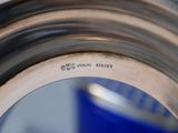 a close up of a metal object with writing on it