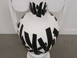 a black and white vase sitting on a pedestal in a room
