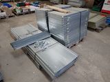 several stacks of steel plates stacked on top of each other in a warehouse