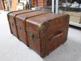 three suitcases stacked on top of each other in front of a store