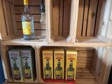 a wooden shelf with three bottles of liquor on it