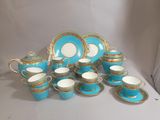 a blue and gold tea set with matching cups and saucers