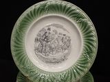 a plate with a picture of a man riding a horse on it