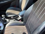 the interior of a car with two leather seats and a steering wheel