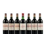 six bottles of red wine lined up in a row