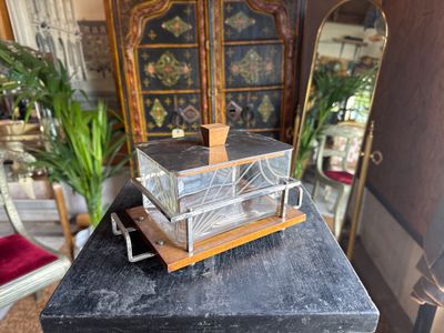 a small glass box on top of a black table