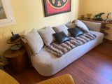 a living room with a white couch and a wooden table