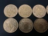 six different british coins are shown in a row on a black surface