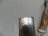 a knife that is sitting next to a knife holder