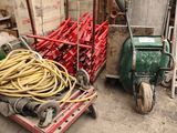 a cart full of hoses next to a pile of other equipment