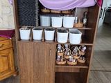 a shelf with pots and pans on it in a room