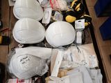 many different types of hard hats and other items on the floor