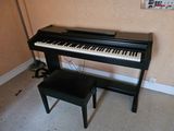 a black piano and a stool in a room