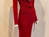 the red dress is on display on a mannequin stand