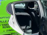 a green car with the door open and the driver ' s seat down