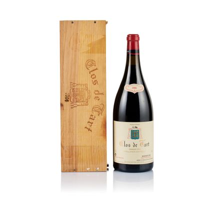 the bottle of wine is next to a wooden box
