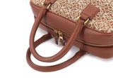 the brown and tan purse is sitting on a white surface