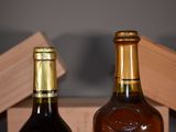 two bottles of wine sitting next to each other on a table