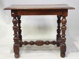 an old wooden table with turned legs and a wooden top