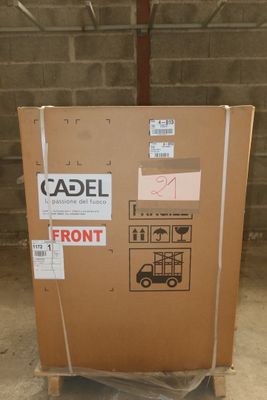 a cardboard box with stickers on it sitting on a pallet