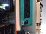 a keyboard and a mouse on a shelf in a room