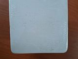 a small white box sitting on a wooden table