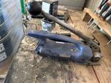 a blue tool sitting on top of a wooden table