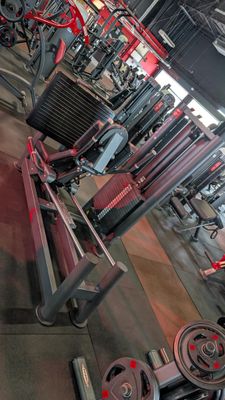 a gym with a lot of machines in the room