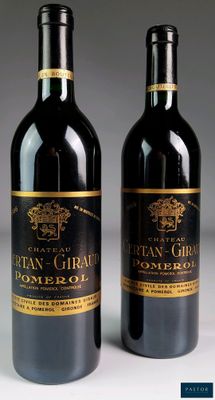 two bottles of wine sitting next to each other on a table