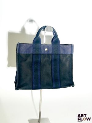 un sac noir et bleu posé sur un support métallique