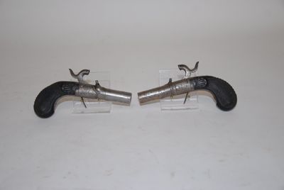 pair of silver and black revolvers on clear acrylic stand