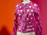 a close up of a mannequin with a pink jacket on it