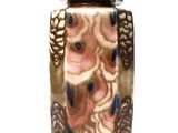 a vase that has a lid on it on a white surface
