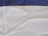 a close up of a piece of cloth with a red and blue stripe