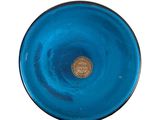 a blue glass plate with a gold coin on it