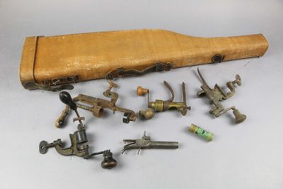 a group of old tools and a wooden case on a table