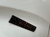 an image of a close up of a ruler on a toilet